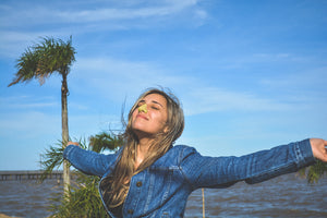 person basking in the sun with Noz reef safe, zinc oxide, yellow sunscreen on her nose